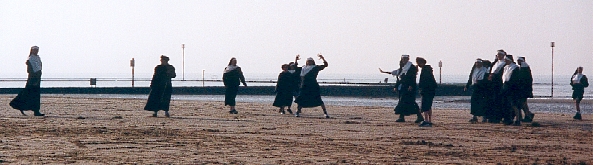 Nuns playing football on the beach
